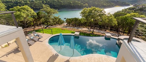 view from balcony overlooking patio and lake