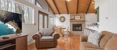 Living room with large windows and door leading to front deck.