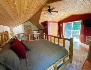The largest bedroom with a private back deck and a beautiful wooden ceiling.