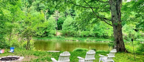 Adirondack chairs by the river.