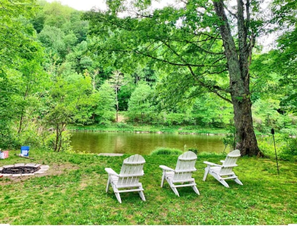 Adirondack chairs by the river.