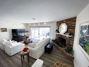 Cozy living room with 80 inch tv, a fireplace & the best view!