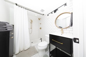 Modern full bathroom with subway tiles.