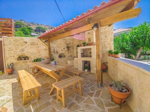 Exterior dining area with barbecue.