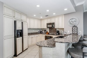 Updated kitchen with tile floors and granite countertops
