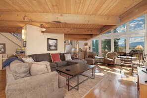 Living area with plenty of seating, TV, games, and access to the wrap around deck.