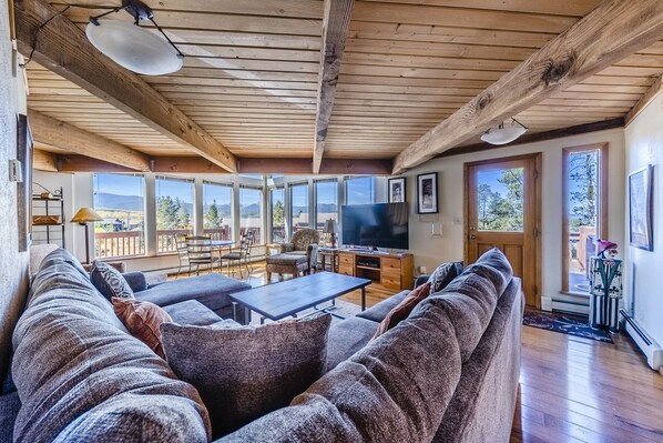 Living Area - Comfortable couch, flat screen TV, and floor to ceiling windows.