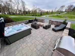 Outdoor Patio with large Hot Tub, Fire Pit, and view of Sight & Sound Theatre