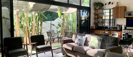 Open floor living with windows to the outdoor patio