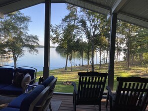 “Sitting porch” view with 4 rocking chairs, 2 sofas, outdoor fireplace and TV