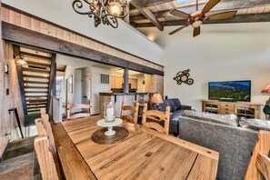 The dining table seats 8, with 2 additional bar stools at the kitchen counter