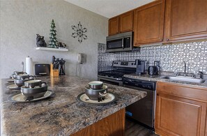 The modern kitchen island accomodates four people and is a great place to gather for meals!