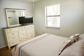 The master bedroom's new furniture allows for a comfy night's sleep in a queen size bed.  It has a flat screen smart TV.