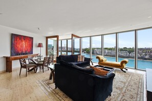 Living room and dining area and winter garden with river views