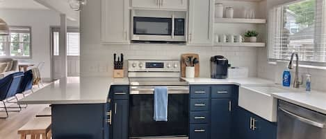 Kitchen stocked with all cups, plates, pots, pans, utensils, etc.