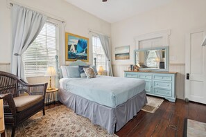 Bedroom 1 features a comfortable queen-sized bed with soft linens, creating a cozy and relaxing atmosphere for your stay. Perfect for a restful night's sleep.