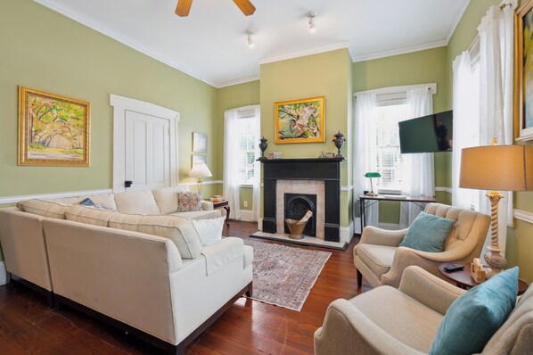 The living room is spacious and inviting, featuring comfortable seating, a flat-screen TV, and plenty of natural light. It's the perfect spot to relax and unwind after a day of exploring.