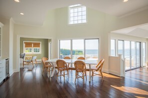 dining area with wine fridge, ice machine, open to kitchen, beautiful ocean view