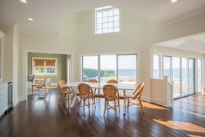 dining area with wine fridge, ice machine, open to kitchen, beautiful ocean view