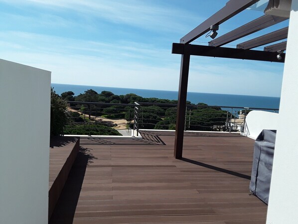 Our roof terrace with decked seating , table, chairs and gazebo shade