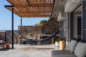 A pergola with a sofa by the pool is also available.