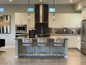 Spacious kitchen with seating for three.