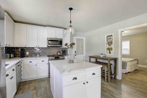 Lucky One is a two bedroom, 1 bath cottage house. Pictured is the kitchen and access to the second bedroom.