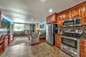 The open concept floor plan means you don't have have to choose between cooking and socializing. The full kitchen has stainless steel appliances, including a freezer/fridge, oven, microwave and dishwasher.