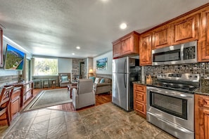 The open concept floor plan means you don't have have to choose between cooking and socializing. The full kitchen has stainless steel appliances, including a freezer/fridge, oven, microwave and dishwasher.