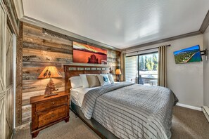 The master bedroom has a king bed, HDTV, and sliding glass doors to the balcony.