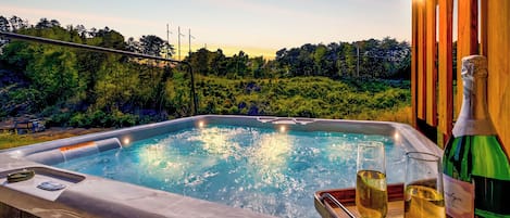 Our hot tub with a breathtaking view is the ultimate way to soak in serenity.