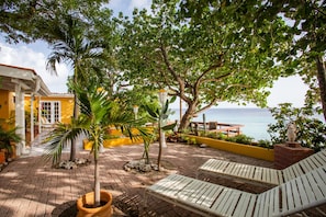 Garden seaside with comfortable loungers in the shade. 