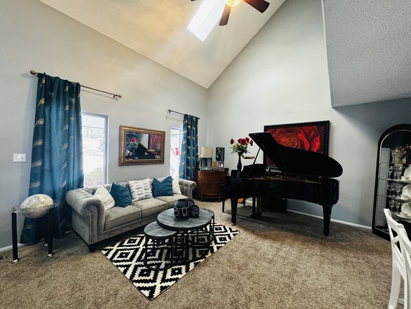 Vaulted ceiling with skylights & Grand Piano