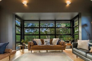 Lounge with cantilevered window with bushland views