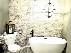 Freestanding bathroom, with beautiful real rock accent wall, custom double vanity, stall shower (not shown in pictures)