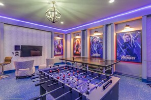 Amazing arcade room with game consoles, foosball, ping pong table, and air hockey