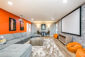 Stunning movie room with projection screen and comfortable sofa