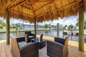 tiki hut with seating on the water