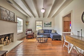 The living room is complete with cozy furnishings.