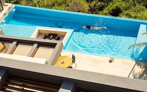 Sunny patio with infinity pool and ocean view