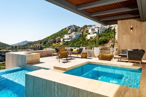 Sunny patio with infinity pool and jacuzzi