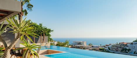 Sunny patio with infinity pool and ocean view