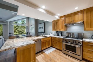 Fully stocked kitchen with stainless steel appliances. 