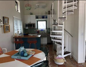 Dining-kitchen view from entrance 
Showing stairs to loft bedroom/bathroom