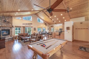 Open concept living area with towering wood beam ceilings.