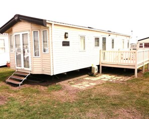 Decking to side entrance. Patio doors to front