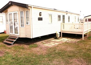Decking to side entrance. Patio doors to front