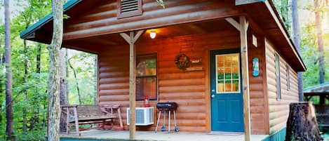 Main entry door. Charcoal grill & utensils w/ porch swing. Charcoal not provided
