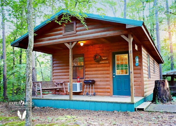 Main entry door. Charcoal grill & utensils w/ porch swing. Charcoal not provided