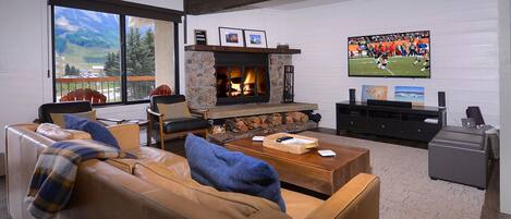 Living area, wood fireplace & smart TV